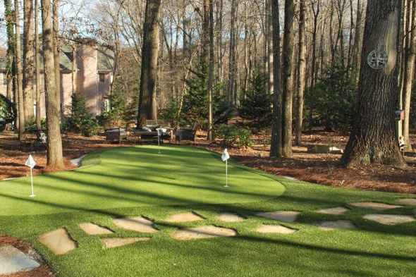 Charlotte backyard putting green with flags and trees